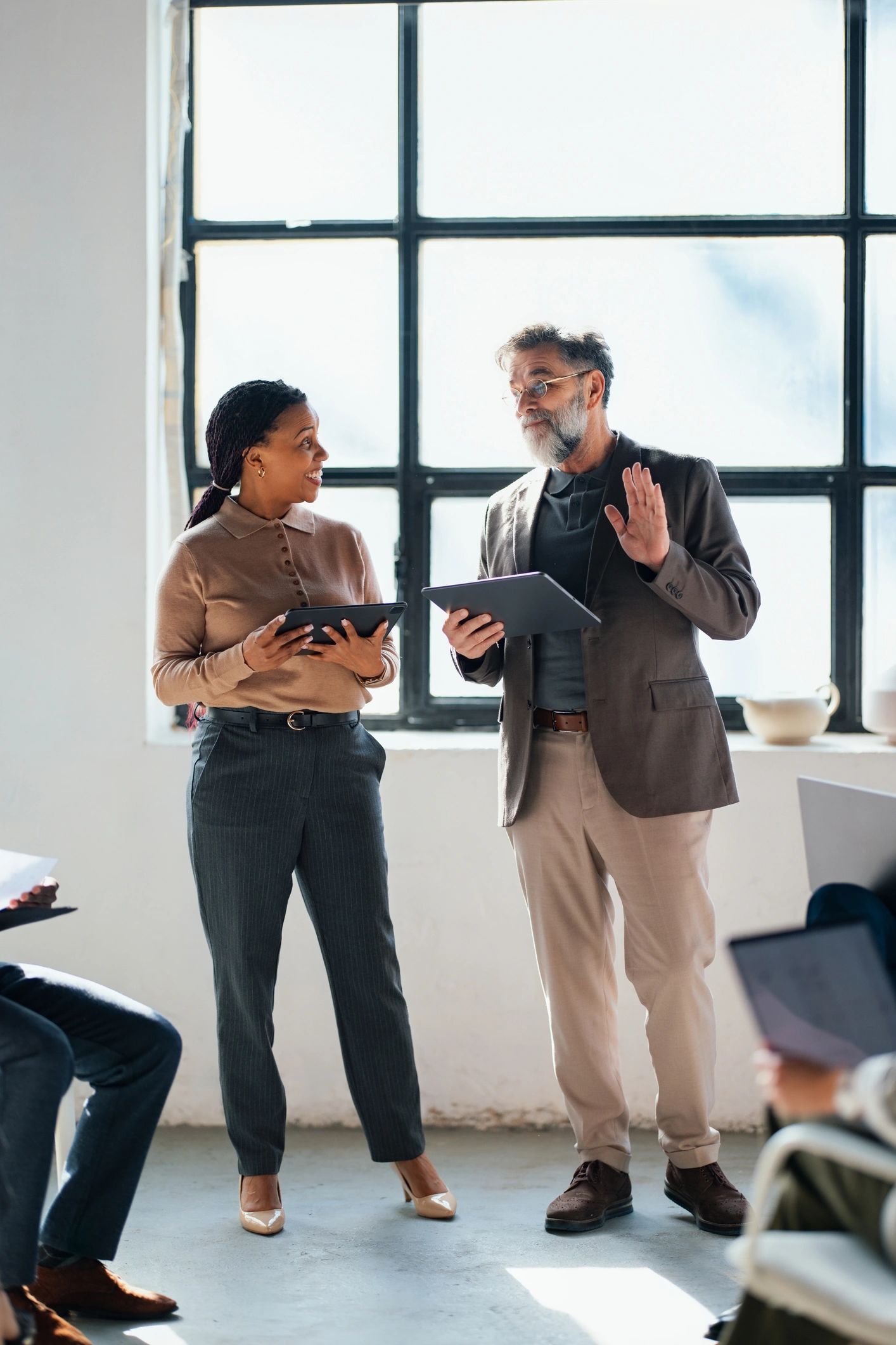 Two professionals discussing strategy in an office