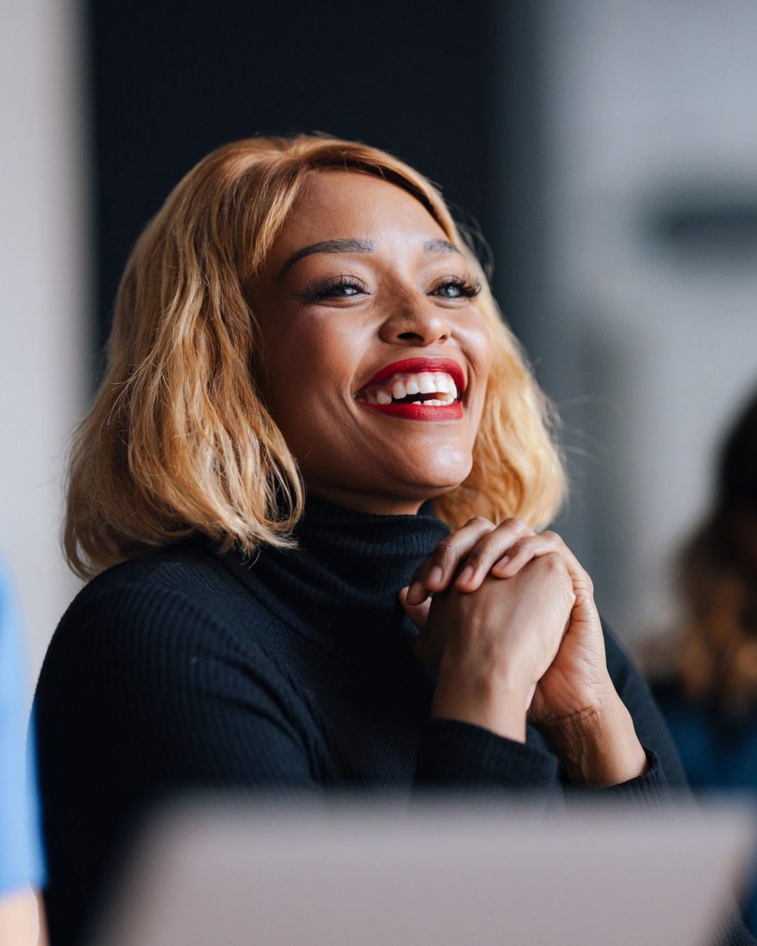 Smiling Businesswoman Engaged in Office Meeting With Colleagues During Corporate Group Discussion